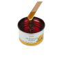 Wax applicator being drawn from an open can of GiGi All Purpose Honee featuring its honey-like color and thick consistency thumbnail